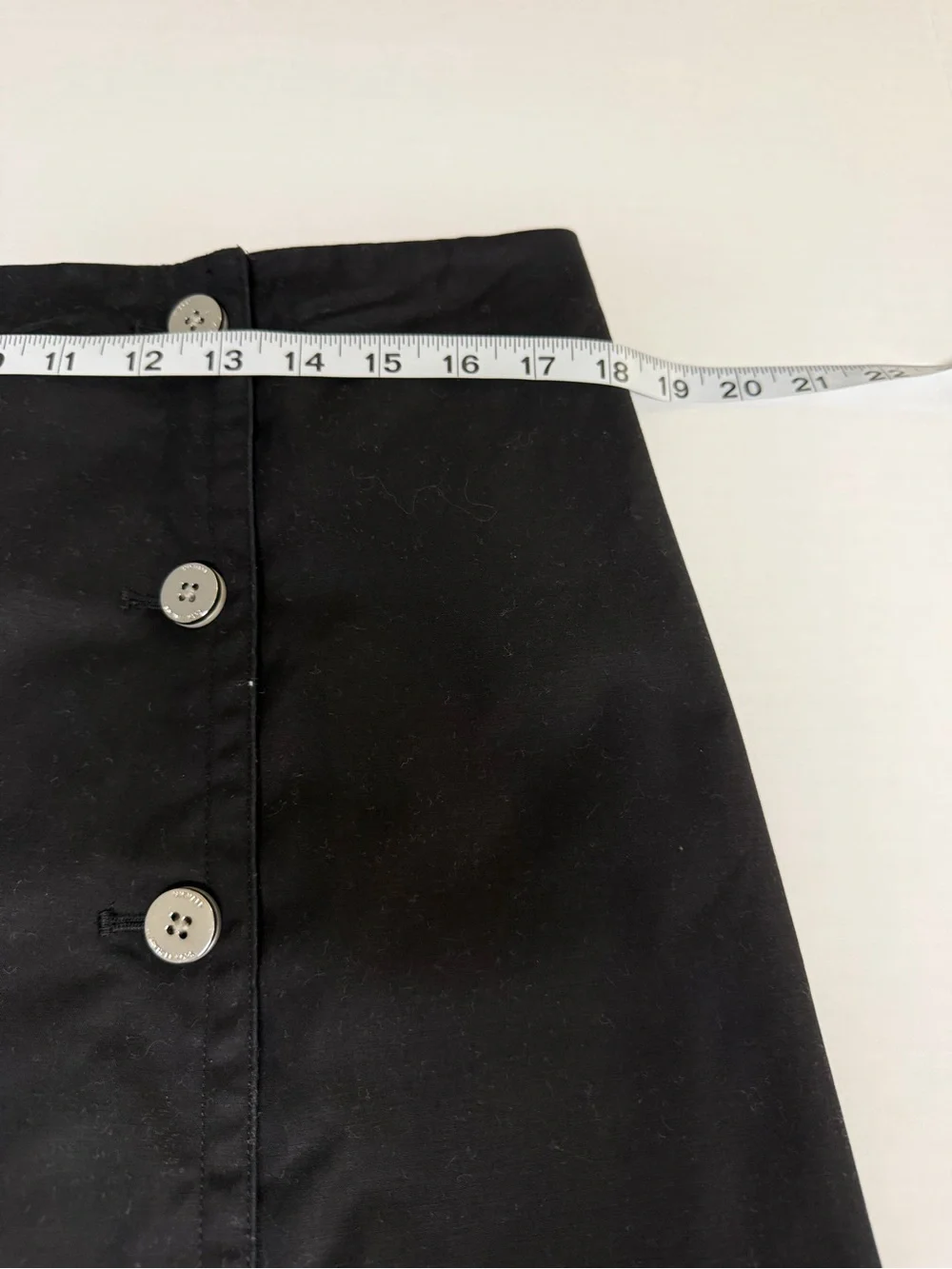 Michael Kors black lined mini skirt with double row silver buttons